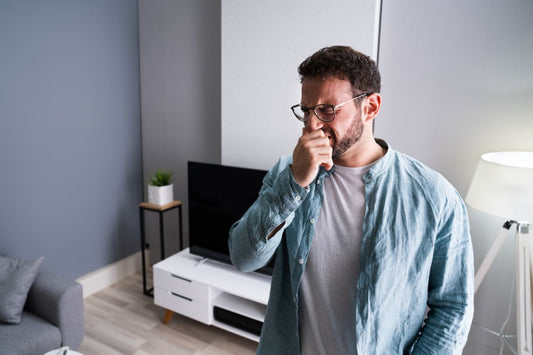 man holding his nose from a bad smell